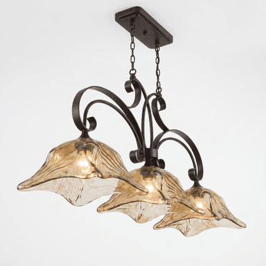 A multi-light chandelier featuring a dark bronze-finished metal frame with ornate scrollwork arms. It is suspended by chains from a rectangular ceiling canopy. The chandelier supports three bell-shaped light shades made of amber-colored art glass with a fluted or textured surface, designed to resemble flower petals. Each shade houses a single light bulb. — 3D model