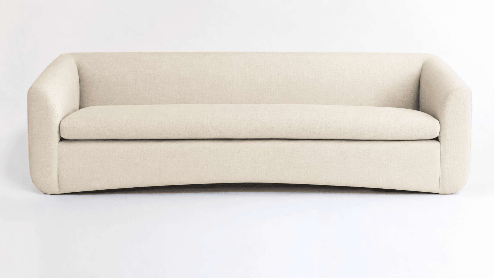 A contemporary sofa featuring a single, long seat cushion and an integrated back and armrest structure, all upholstered in a light beige textured fabric. The arms are gently rounded, flowing into the backrest. The base has a subtle curve, and the overall aesthetic is clean and minimalist. — 3D model