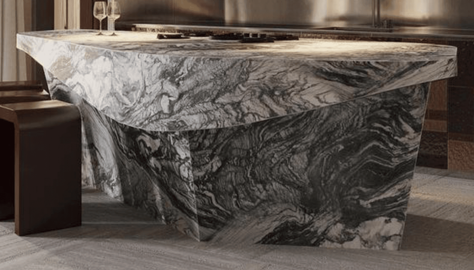 A long, contemporary reception desk crafted entirely from highly veined marble, featuring an irregular, faceted base and a subtly contoured top surface, designed for a modern aesthetic. — 3D model