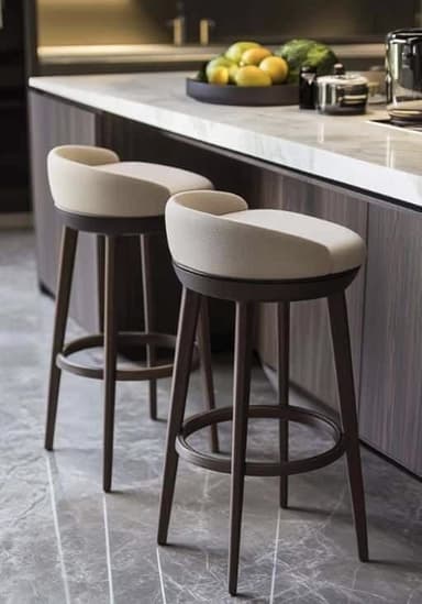 A contemporary bar stool featuring a comfortable upholstered seat and a low, curved backrest, supported by a sturdy four-legged wooden frame with a circular footrest. The upholstery is a light, possibly off-white, textured material, contrasting with the dark brown finish of the tapered wooden legs. — 3D model