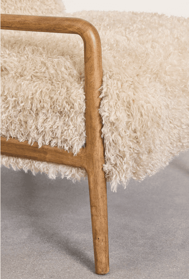 A cream-colored armchair with a textured, fluffy upholstery. The frame and armrests are made of polished wood, featuring a minimalist design with gently curved lines. The chair rests on four wooden legs. — 3D model