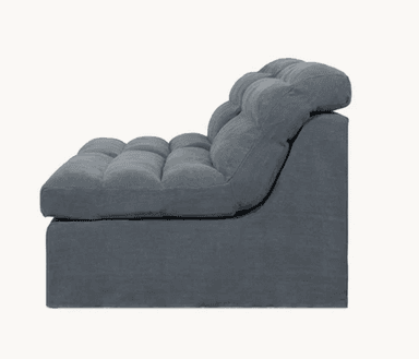 A modular sofa section with a low profile and deep seating. The design features a tufted cushion top with channel stitching, creating a segmented appearance. The base is a solid, upholstered block. The backrest curves gently upwards and appears to be integrated with the seating. — 3D model