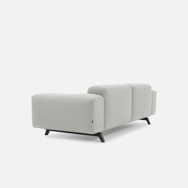 A modern upholstered sofa in a light grey fabric, featuring two main seat and back cushions, with integrated wide armrests and two bolster cushions. The sofa is supported by dark, minimalist metal legs. — 3D model