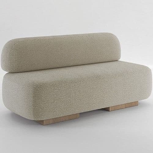 A modern, armless sofa with a rounded silhouette. The sofa features a textured upholstery and a low-profile wooden base. The backrest is a singular, curved piece that appears to be integrated with the seat. Its design suggests a modular or standalone seating unit. — 3D model