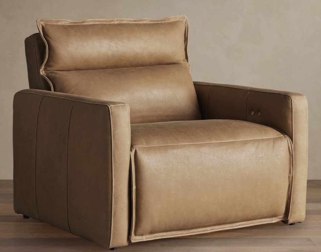 A contemporary recliner armchair upholstered in a tan or camel-colored leather, featuring thick cushioning, square-profile arms, and visible topstitching. — 3D model