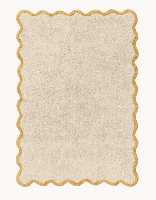 A rectangular area rug featuring a cream-colored, textured pile surface and a distinctive scalloped border in a contrasting golden-beige hue. The border has a braided or woven appearance, clearly defining the wavy edge of the rug. — 3D model