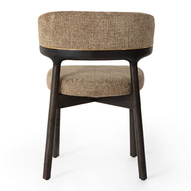 A modern upholstered chair with a dark wood frame and a curved backrest. The seat and backrest are upholstered in a textured, speckled fabric. A thin gold trim detail accents the top edge of the backrest. The chair has four tapered legs. — 3D model