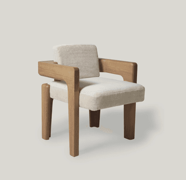 An armchair with a distinct contemporary design. The frame is constructed from light-colored wood with a visible grain, featuring robust legs and armrests. The seat and backrest are upholstered in a textured, off-white fabric that appears soft and plush. The design incorporates geometric shapes, with the wooden elements forming block-like structures that cradle the upholstered cushions. — 3D model