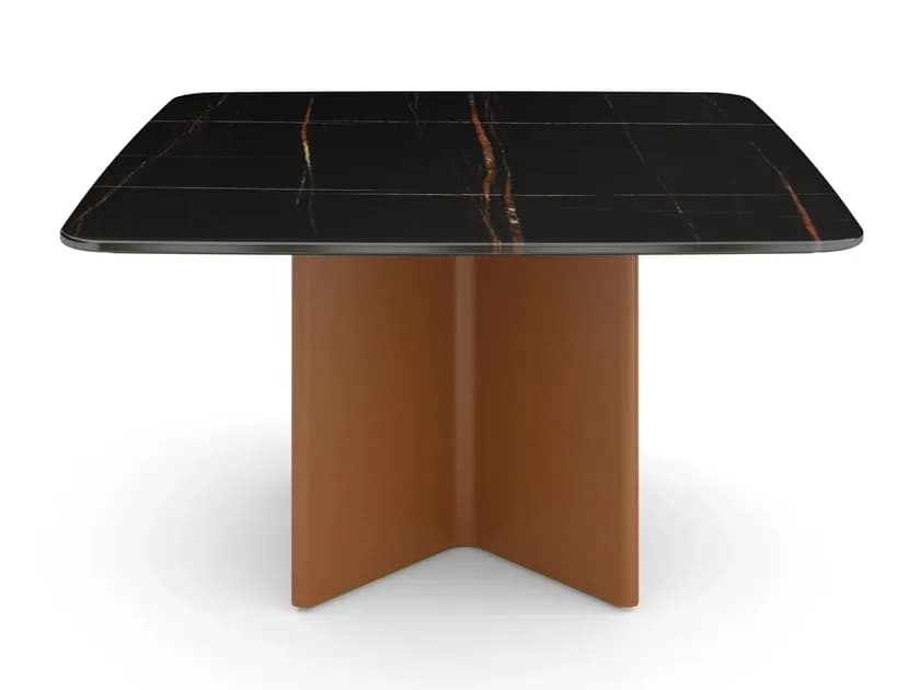 A contemporary square-shaped dining table featuring a black marble top with distinctive gold-copper veining, supported by a sculptural, rectangular pedestal base in a matte tan finish. The tabletop has subtly rounded corners, enhancing its modern aesthetic. — 3D model