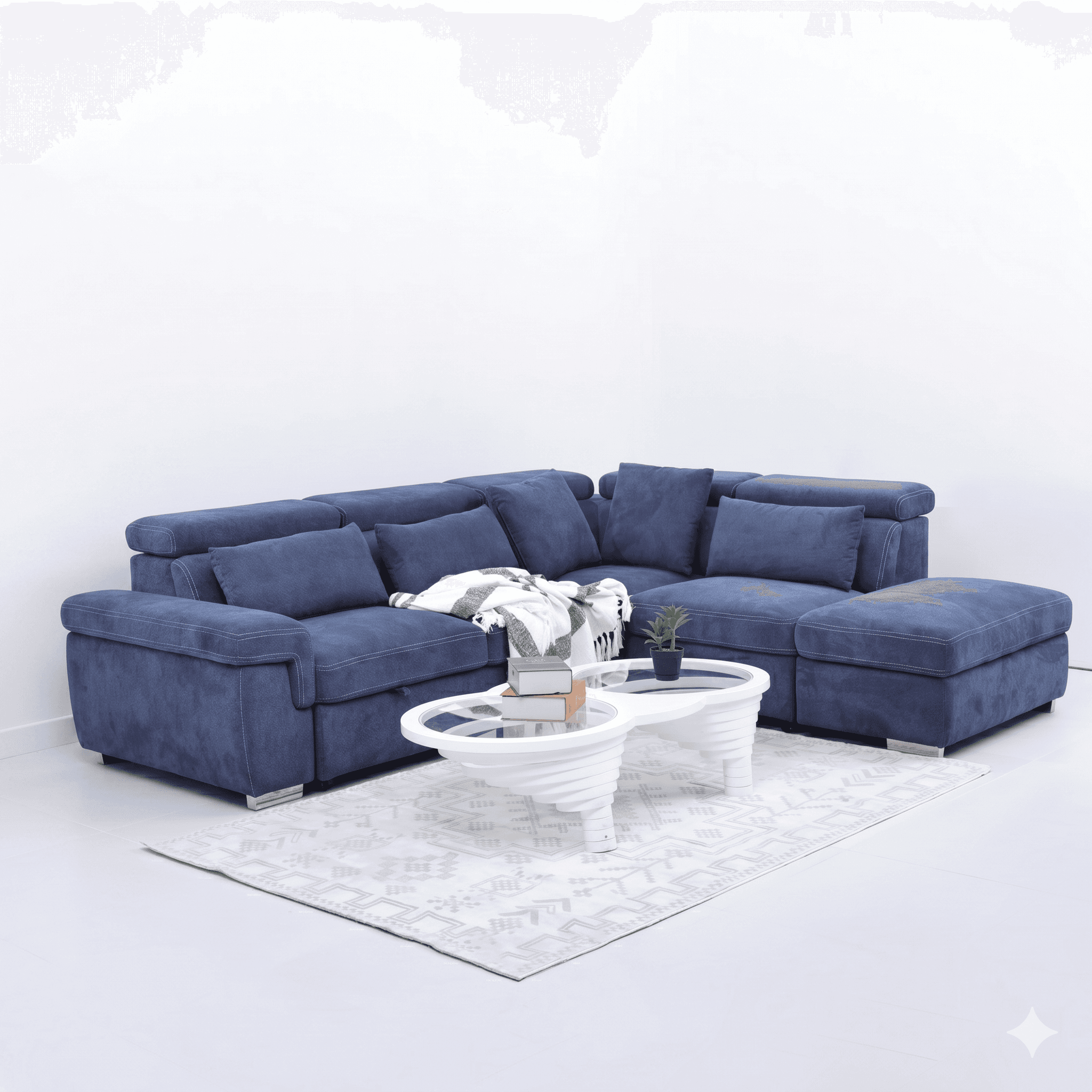 A deep blue fabric sectional sofa with plush cushions and contrasting white stitching. The configuration includes a corner seat, armrests, and an extended ottoman or chaise lounge section. The sofa features adjustable headrests and sits on modern, low-profile metallic feet. A patterned throw blanket is draped over one section, and a small decorative plant and two books rest on a white, multi-tiered coffee table in front of the sofa. — 3D model