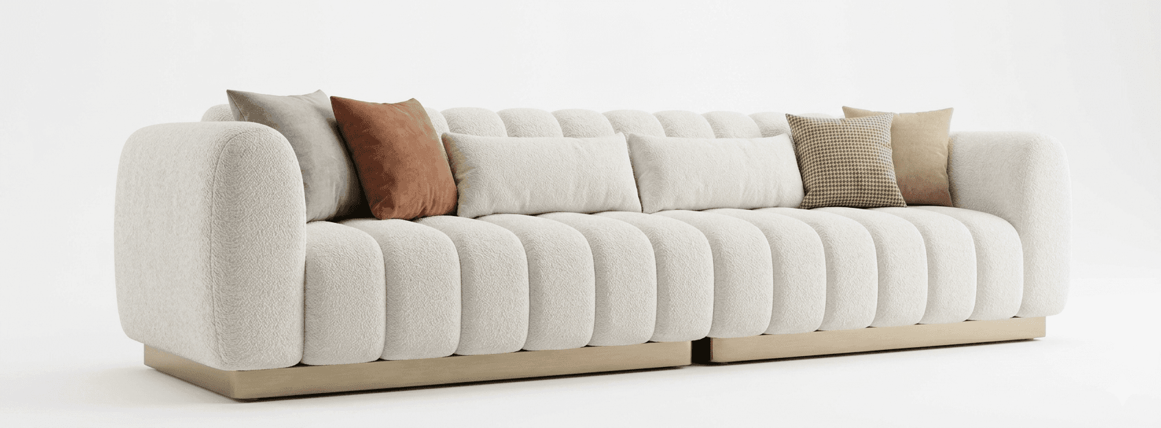 A large, upholstered sofa with a fluted design on the seat and back cushions. It features rounded armrests and sits on a low-profile base. The sofa is adorned with several throw pillows in various colors and patterns. — 3D model