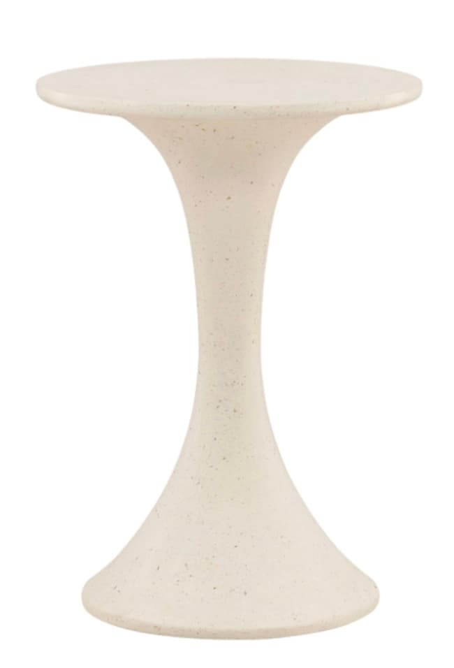 A modern, minimalist accent table featuring a round, flat tabletop and a single, flared pedestal base. The table has an hourglass-like silhouette, narrowing in the middle and flaring out at both the top and bottom. It is made from a light-colored, possibly off-white or cream, composite material with subtle dark speckles, giving it a textured, stone-like appearance. The design is clean and sculptural. — 3D model