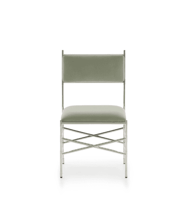 A contemporary side chair featuring a polished metal frame and upholstered seat and back. The frame is slender and appears to have decorative, possibly bamboo-inspired, joint detailing. The seat and backrest are upholstered in a light sage green fabric. The chair includes X-shaped stretchers for stability. — 3D model