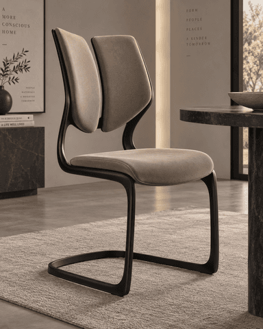 An armless modern dining chair featuring a cantilever base, upholstered seat, and a distinctive split backrest design. The frame is a dark, possibly black, metal, providing a sleek contrast to the light beige fabric. — 3D model