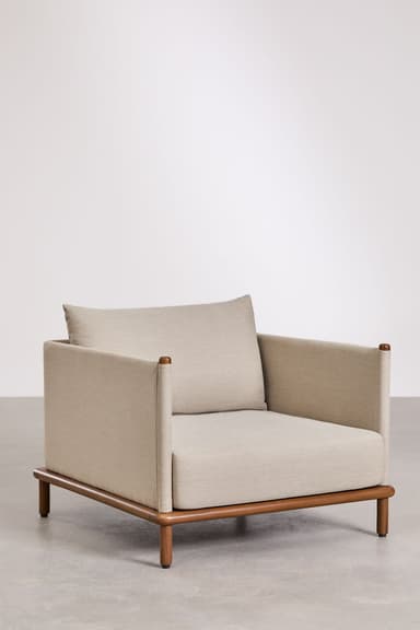 A modern lounge chair featuring a plush, upholstered body in a light beige/grey fabric set upon an exposed, warm-toned wooden base. The chair has a boxy, minimalist design with integrated, low armrests and a loose, rectangular back cushion. The slender, cylindrical wooden legs are slightly splayed, providing stability and contributing to the chair's contemporary aesthetic. — 3D model