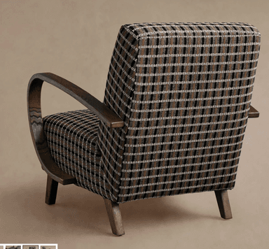 An upholstered armchair featuring a distinctive plaid pattern in dark brown, black, and cream, set against dark stained wooden arms and tapered legs. The design combines a classic aesthetic with modern lines, suitable for various interior settings. The wooden armrests exhibit a smooth, curved shape, providing a comfortable resting place. — 3D model