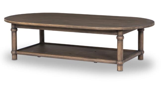 An oval-shaped coffee table with a lower shelf. The table features four turned legs with a bulbous detail at the top and bottom, supporting an oval tabletop and a rectangular lower shelf. The construction appears to be made of wood with a distressed finish. — 3D model