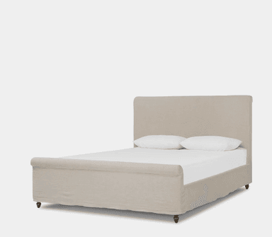 An upholstered bed featuring a rectangular headboard and a fabric-wrapped frame, supported by turned wooden feet, presented against a plain background. — 3D model