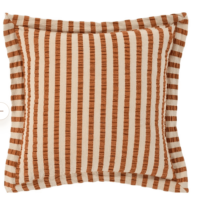 A square decorative throw pillow featuring a prominent vertical striped pattern in alternating shades of cream/beige and a warm rust/terracotta color. The fabric has a visible woven texture, giving it a tactile quality. The pillow is finished with a flanged edge, where the fabric extends beyond the main seam and is then sewn down, framing the central pattern. It appears to be new and in pristine condition, presented against a white background. — 3D model