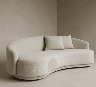 A modern, light beige boucle sofa featuring a distinctive curved or serpentine silhouette, with a continuous low-profile backrest that seamlessly integrates into arms. It has a plush, textured appearance and rests on a subtly recessed base, accompanied by two matching throw pillows. — 3D model