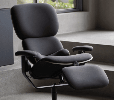 A sophisticated, high-tech reclining chair featuring multiple articulated segments for customized ergonomic support. The chair is upholstered in a dark gray fabric with lighter gray trim, set upon a robust, light gray metal frame that showcases advanced adjustability mechanisms for the backrest, seat, armrests, and integrated footrest. Its design emphasizes comfort and modern aesthetics. — 3D model