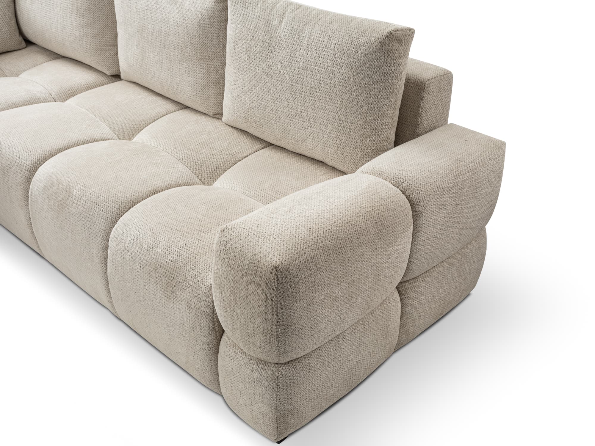 A modern modular sectional sofa upholstered in a light beige textured fabric. It features a deeply cushioned, pillow-like construction with soft, rounded forms for both the seat and backrest cushions, as well as the armrest. The overall design emphasizes comfort and a plush aesthetic, suggesting a relaxed seating experience. — 3D model