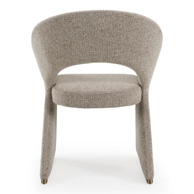 A contemporary, fully upholstered accent chair featuring a distinctive sculptural form. The backrest curves continuously, seamlessly integrating with the solid, geometric base. It is covered in a textured, light beige fabric, and subtle brass accents are visible at the bottom of the base. — 3D model