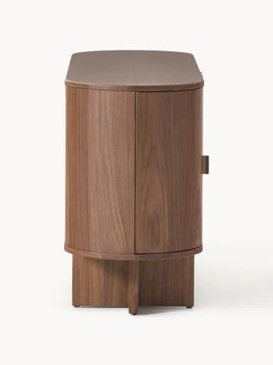 A mid-century modern inspired cabinet with a rounded, cylindrical body and a plinth base. It features two vertically oriented doors with concealed handles and a curved top surface. The material appears to be solid wood with a prominent grain pattern. — 3D model