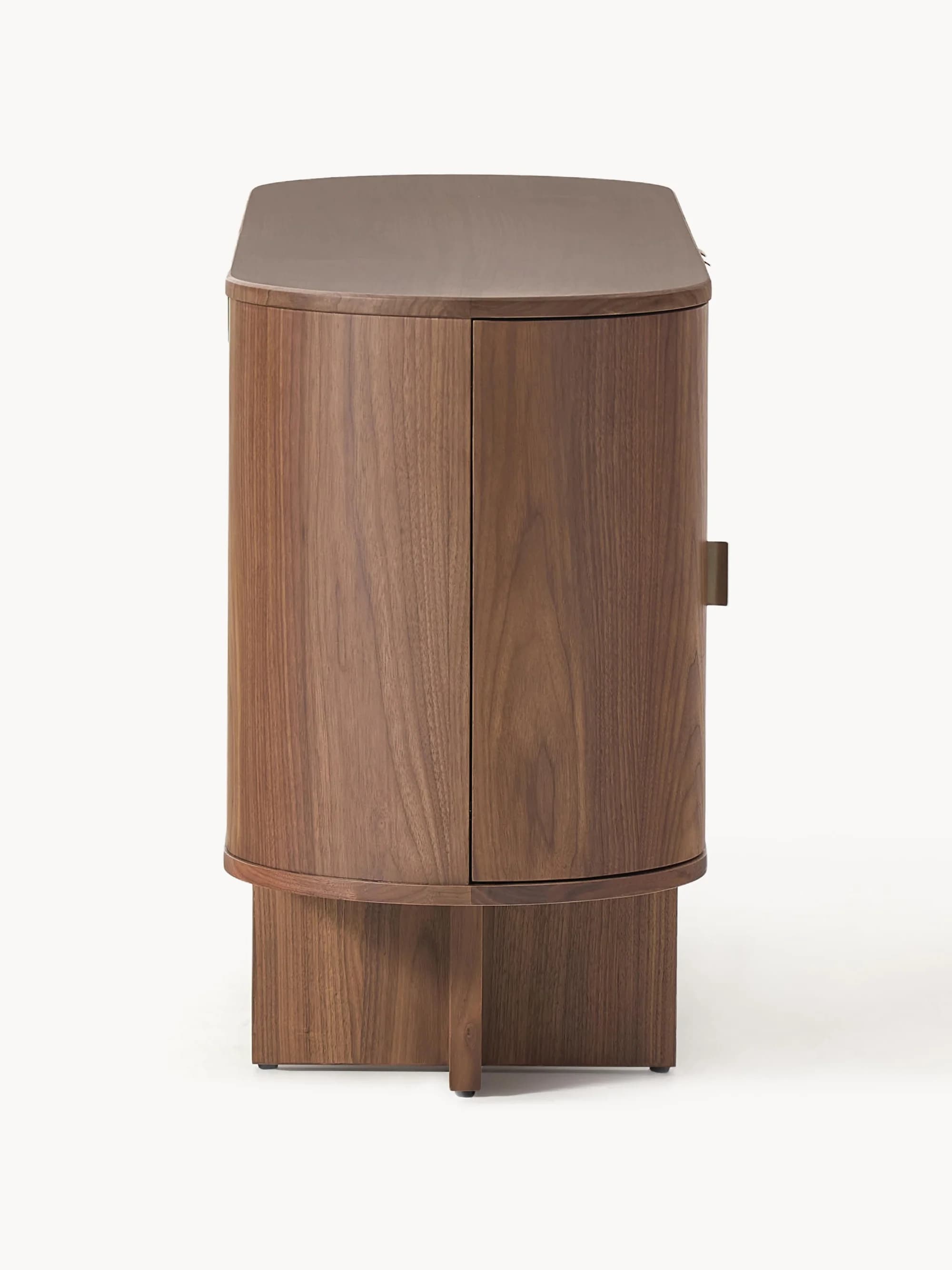 A mid-century modern inspired cabinet with a rounded, cylindrical body and a plinth base. It features two vertically oriented doors with concealed handles and a curved top surface. The material appears to be solid wood with a prominent grain pattern. — 3D model