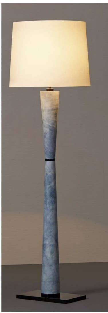 A floor lamp with a tapered, cylindrical body featuring a mottled blue and white pattern, reminiscent of marble or stone. The body narrows towards the top and has a black band detail. It is topped with a rectangular, off-white lampshade. The base is a flat, dark rectangular platform. — 3D model