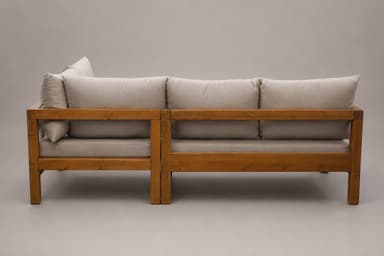 An L-shaped sectional sofa featuring an exposed wooden frame with square legs and armrests, paired with light-colored, plush fabric seat and back cushions. — 3D model