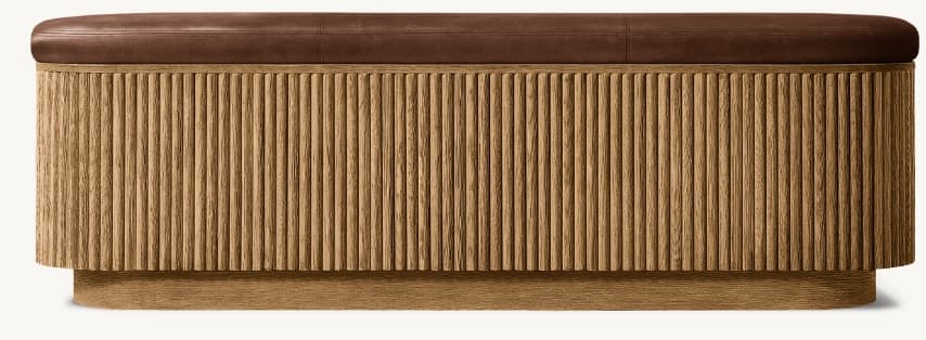 An elongated oval bench featuring a brown leather upholstered top and a base constructed from vertically reeded natural wood. The base maintains an oval form, slightly narrower than the top, and rests on a subtle plinth. — 3D model