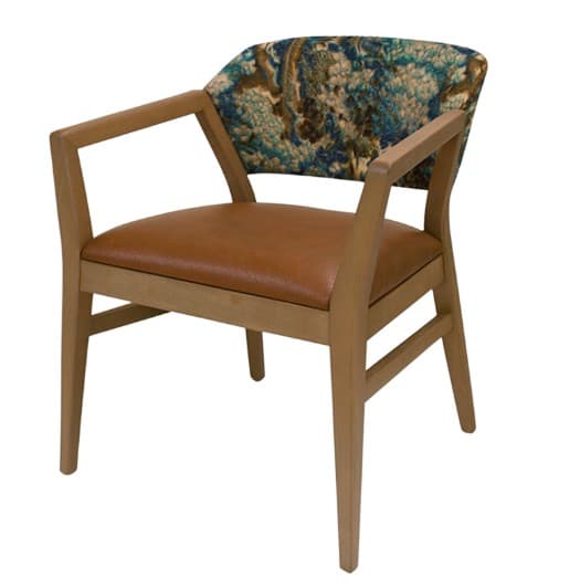 An armchair featuring a light-toned wooden frame, a tan faux leather upholstered seat, and a curved backrest upholstered in a multi-colored patterned fabric. The armrests are open and integrated into the wooden frame, with the chair resting on four tapered wooden legs. — 3D model