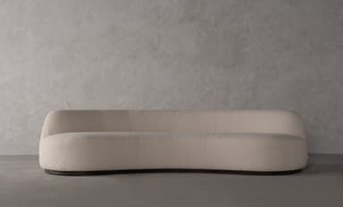A contemporary curved sofa with a textured upholstery and a flowing, organic shape. The sofa features a single continuous seat and backrest, with no visible arms. The silhouette is sleek and modern, designed to fit within a variety of interior design schemes. — 3D model