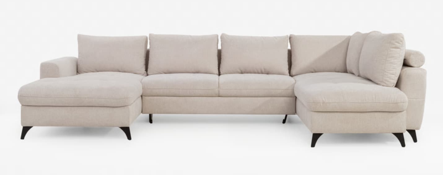 A contemporary U-shaped sectional sofa upholstered in a light beige fabric, featuring deep seats, track arms, and two chaise lounge extensions on either end. The sofa is supported by slender, dark-finished tapered legs, and includes multiple loose back cushions for comfort. — 3D model