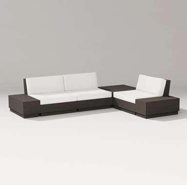 A modern sectional sofa composed of multiple modular units. The base and armrests are constructed from dark-colored material, forming a cohesive and blocky structure. The seating and back cushions are upholstered in a light, neutral fabric, providing a contrast to the darker frame. The configuration suggests an L-shaped arrangement, suitable for contemporary living spaces or outdoor patios. — 3D model