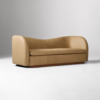 A contemporary two-seater loveseat upholstered in tan leather with a curved back and integrated armrests, resting on a dark wooden plinth base. — 3D model