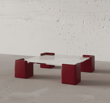 A modern coffee table featuring a clear glass top supported by four distinct, cube-like legs finished in a deep red matte lacquer. The legs have rounded corners and a substantial, blocky appearance, creating a strong visual contrast with the delicate glass surface. — 3D model