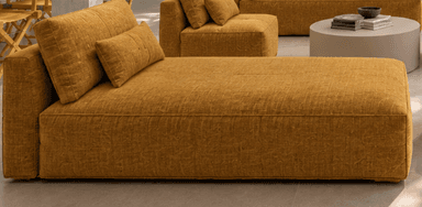 A modern chaise lounge upholstered in a textured mustard yellow fabric, featuring a fixed backrest and an additional bolster cushion. — 3D model