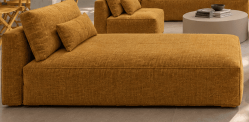 A modern chaise lounge upholstered in a textured mustard yellow fabric, featuring a fixed backrest and an additional bolster cushion. — 3D model