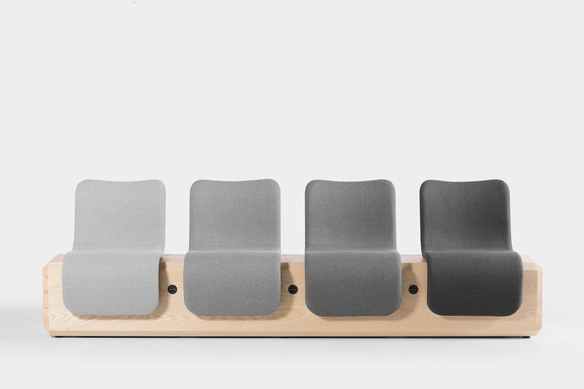 A four-seat modular waiting room bench with individual upholstered seats on a wooden base. — 3D model