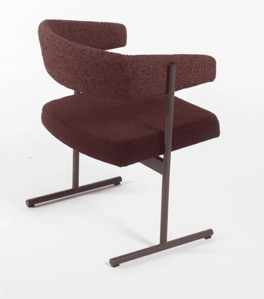 A modern upholstered armchair featuring a distinctive curved backrest that seamlessly transitions into armrests. The chair is supported by a minimalist dark brown metal sled base, giving it a contemporary floating appearance. The seat and backrest are covered in a rich maroon or burgundy-colored textured fabric, possibly bouclé, providing both comfort and visual interest. The design is clean and architectural, emphasizing form and material. — 3D model