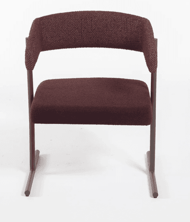 A modern upholstered armchair featuring a distinctive curved backrest that seamlessly transitions into armrests. The chair is supported by a minimalist dark brown metal sled base, giving it a contemporary floating appearance. The seat and backrest are covered in a rich maroon or burgundy-colored textured fabric, possibly bouclé, providing both comfort and visual interest. The design is clean and architectural, emphasizing form and material. — 3D model