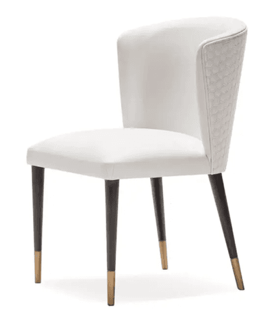 A contemporary white upholstered chair featuring a curved backrest with a distinctive hexagonal quilted pattern on its outer surface. The seat and inner back are smoothly upholstered in white. It stands on four slender, tapered dark legs, each finished with a brass-colored ferrule. — 3D model