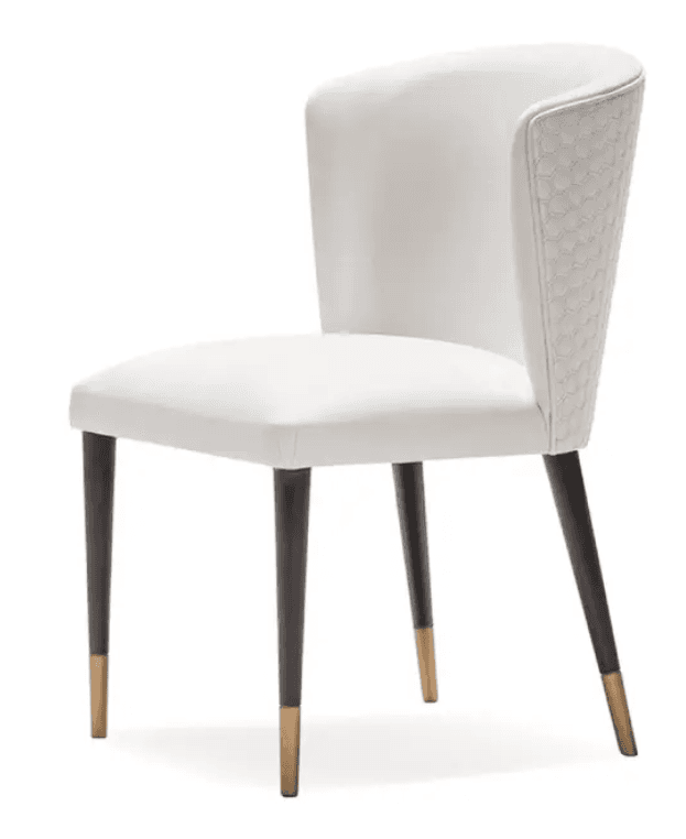 A contemporary white upholstered chair featuring a curved backrest with a distinctive hexagonal quilted pattern on its outer surface. The seat and inner back are smoothly upholstered in white. It stands on four slender, tapered dark legs, each finished with a brass-colored ferrule. — 3D model