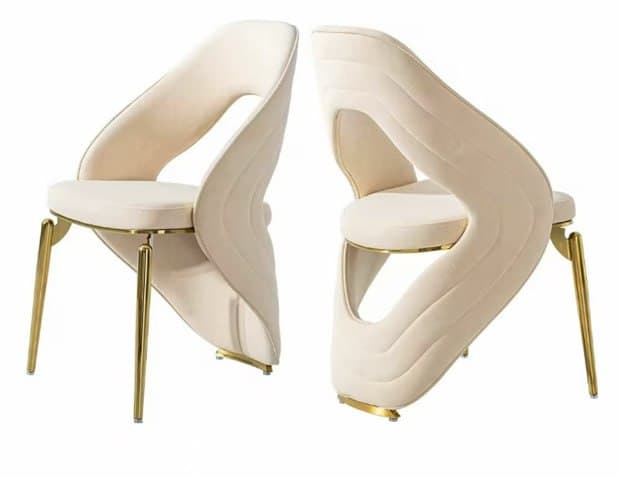 A contemporary armless chair featuring an upholstered, sculptural backrest with a distinctive cut-out design, supported by slender, tapered golden metal legs. — 3D model