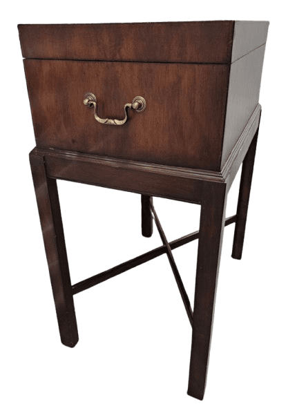 A dark wood, square-shaped cabinet with a brass handle, elevated on a four-legged stand. — 3D model