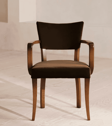 A wooden armchair with upholstered seat and backrest. The chair features curved armrests and four tapered legs. The upholstery is a dark brown fabric, and the wooden frame has a natural wood finish. — 3D model
