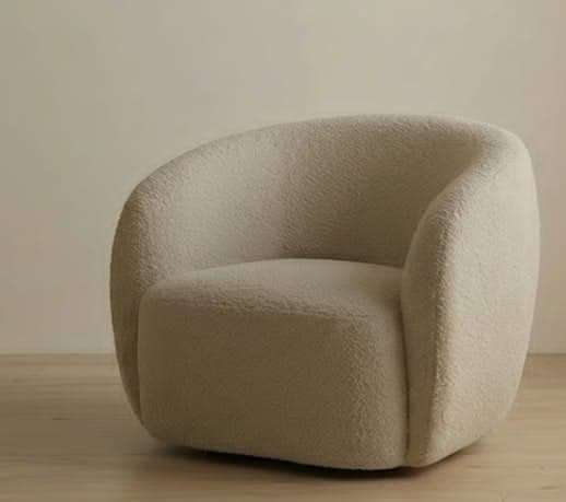 A modern armchair with a rounded, upholstered form. It features a plush, textured fabric and a low profile, creating a cozy and inviting appearance. — 3D model