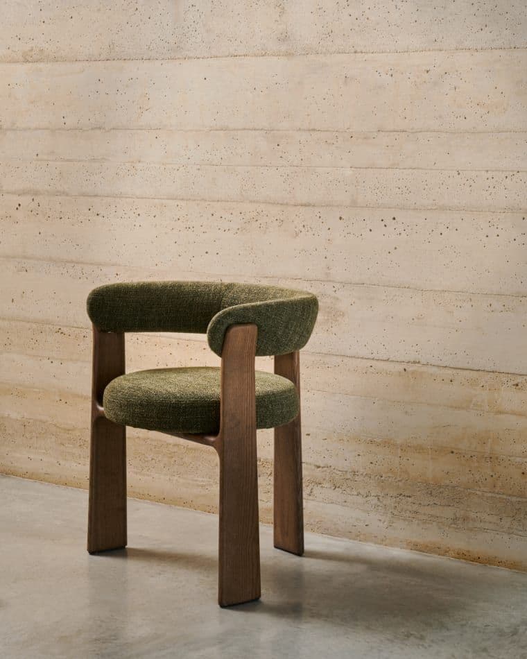 An upholstered dining armchair featuring a curved backrest and integrated armrests, supported by a solid wooden frame. — 3D model